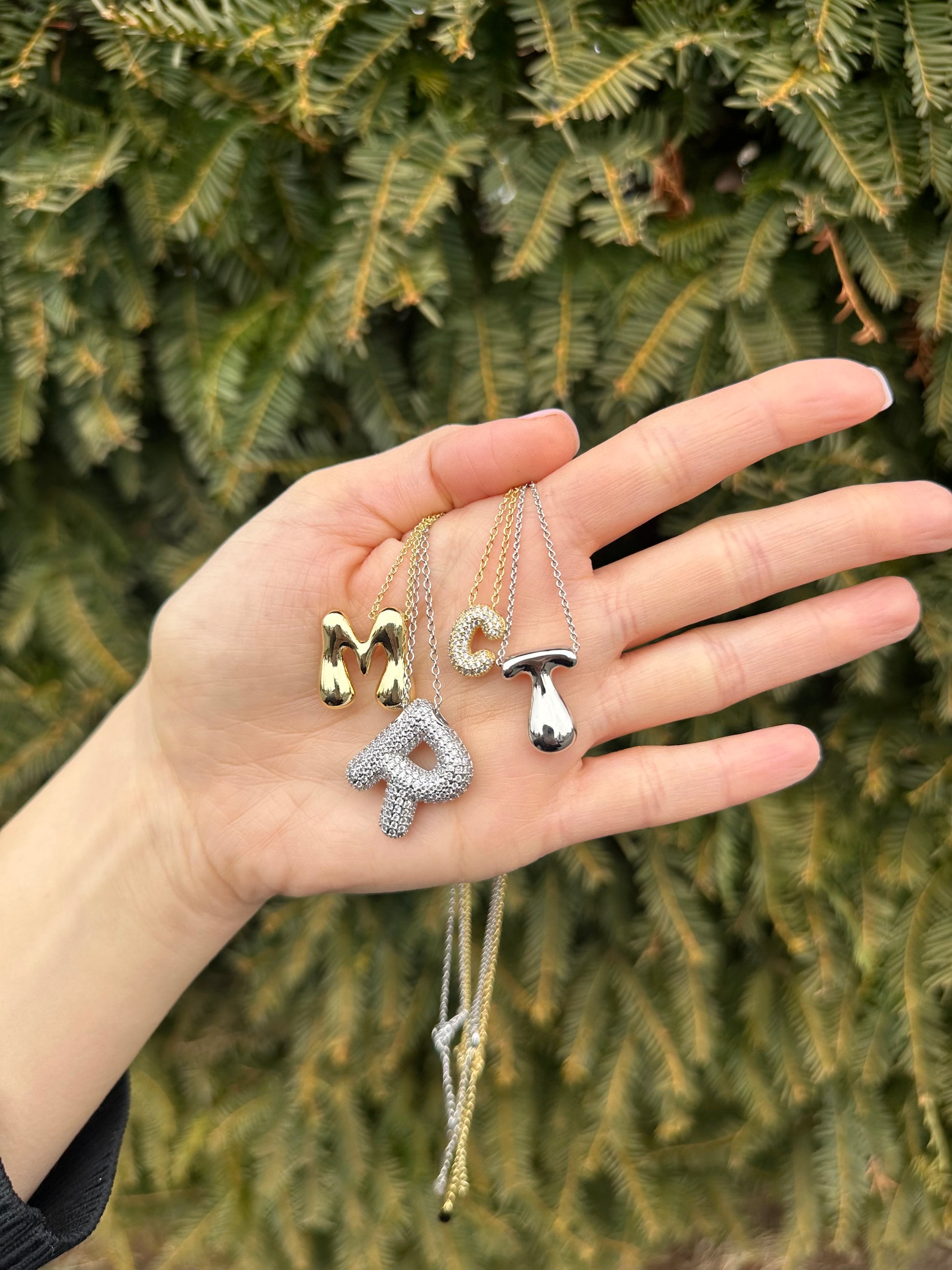 Hailey Bieber-inspired bubble letter initial necklace made from high-quality sterling silver, offering a stylish and durable way to personalize your look with a trendy and chic design. Perfect for layering or solo wear.