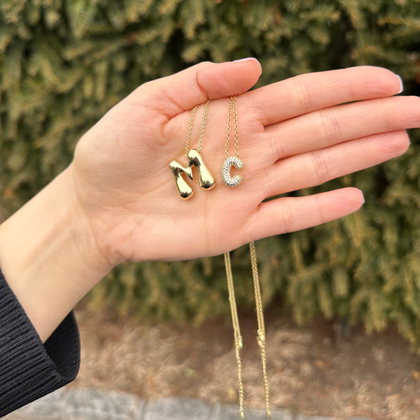 Hailey Bieber-inspired bubble letter initial necklace made from high-quality sterling silver, offering a stylish and durable way to personalize your look with a trendy and chic design. Perfect for layering or solo wear.