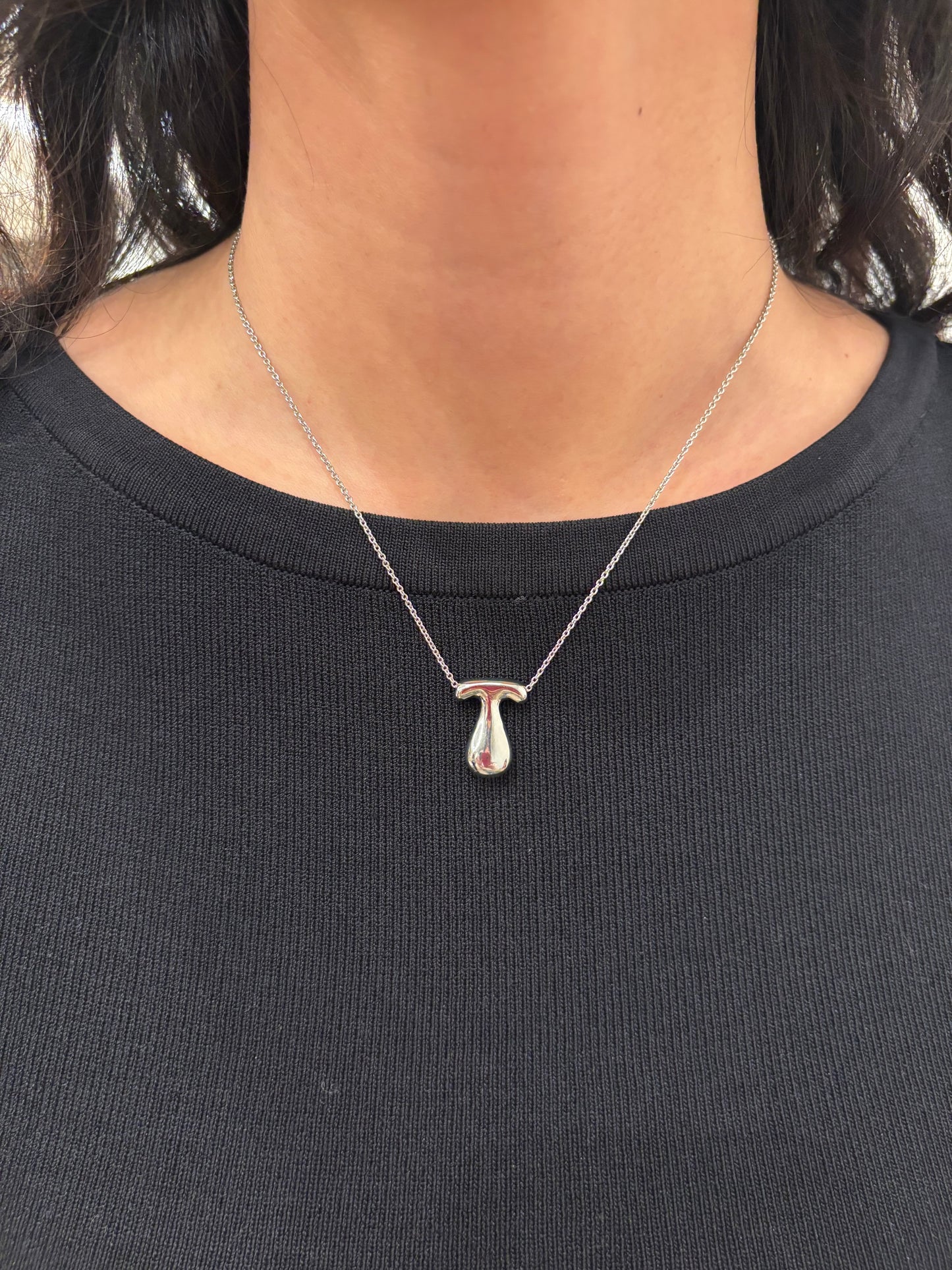Hailey Bieber-inspired bubble letter initial necklace made from high-quality sterling silver, offering a stylish and durable way to personalize your look with a trendy and chic design. Perfect for layering or solo wear.