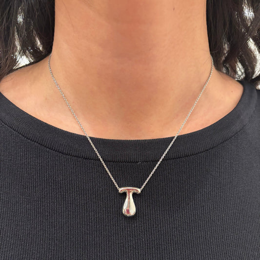 Hailey Bieber-inspired bubble letter initial necklace made from high-quality sterling silver, offering a stylish and durable way to personalize your look with a trendy and chic design. Perfect for layering or solo wear.