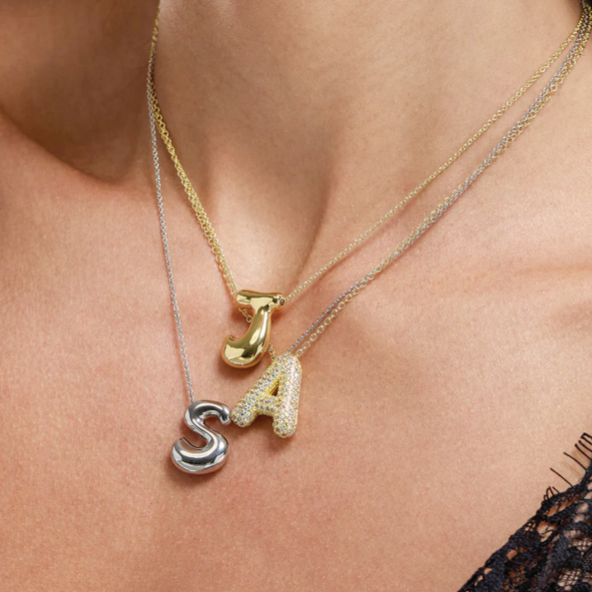 Hailey Bieber-inspired bubble letter initial necklace made from high-quality sterling silver, offering a stylish and durable way to personalize your look with a trendy and chic design. Perfect for layering or solo wear.