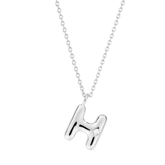 Mini bubble letter initial necklace with bezel, crafted in sterling silver for durability and water-resistance, offering a playful and personalized look for everyday wear.