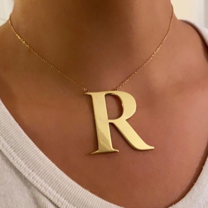 Oversized initial necklace in Times New Roman font, crafted from durable, tarnish-resistant sterling silver; personalized minimalist jewelry perfect for gifts or everyday wear.