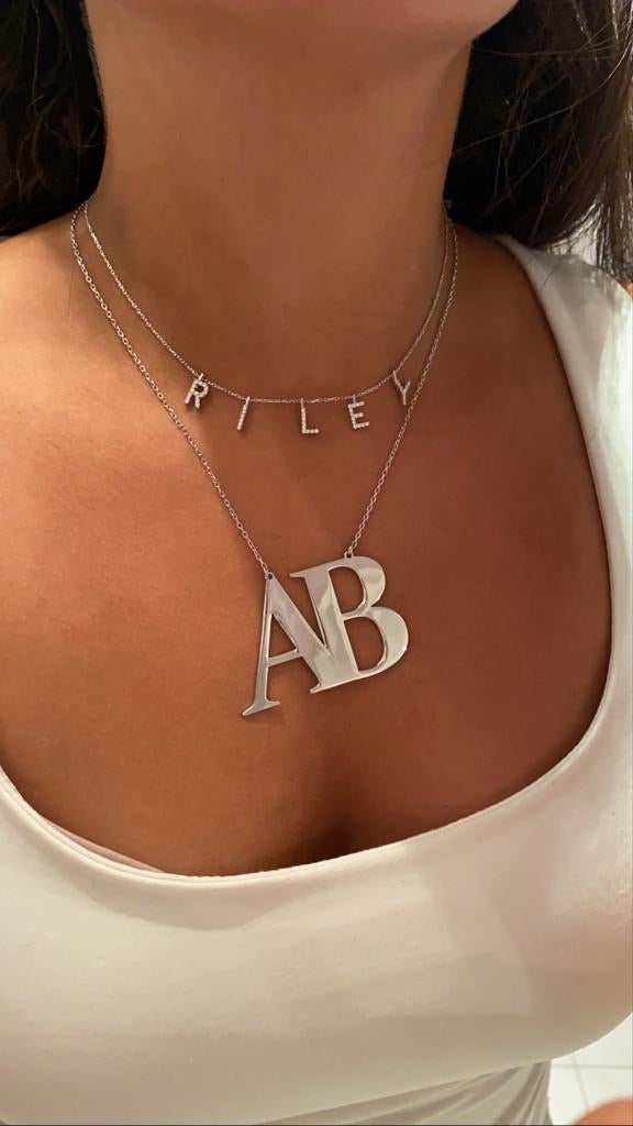 Oversized initial necklace in Times New Roman font, crafted from durable, tarnish-resistant sterling silver; personalized minimalist jewelry perfect for gifts or everyday wear.