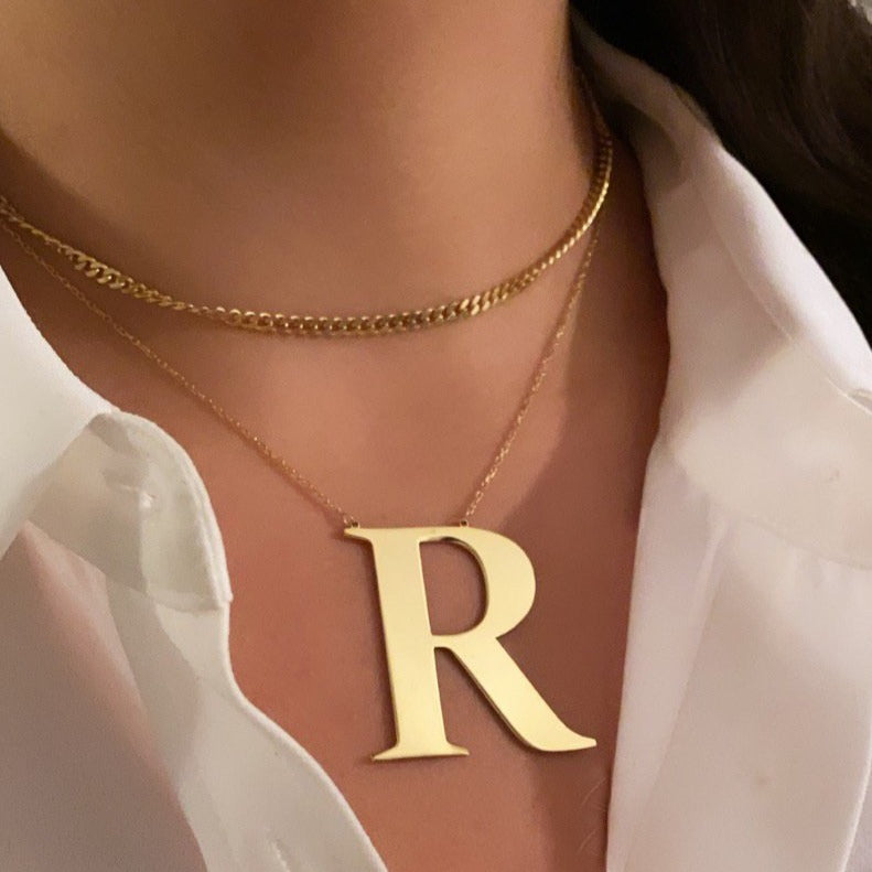Oversized initial necklace in Times New Roman font, crafted from durable, tarnish-resistant sterling silver; personalized minimalist jewelry perfect for gifts or everyday wear.