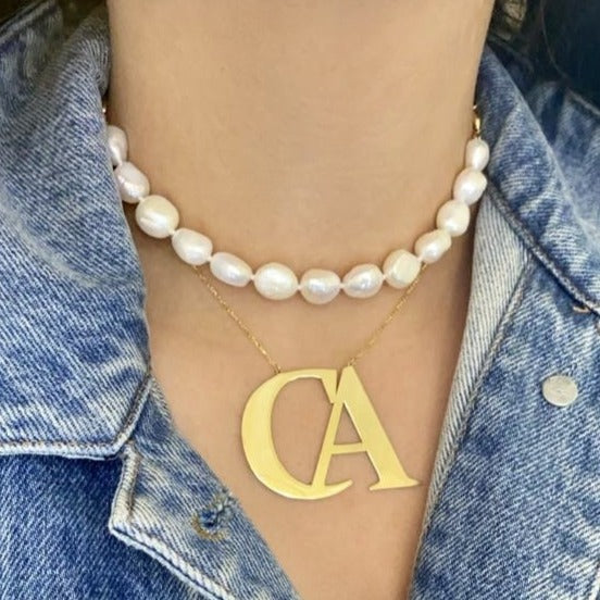 Oversized initial necklace in Times New Roman font, crafted from durable, tarnish-resistant sterling silver; personalized minimalist jewelry perfect for gifts or everyday wear.