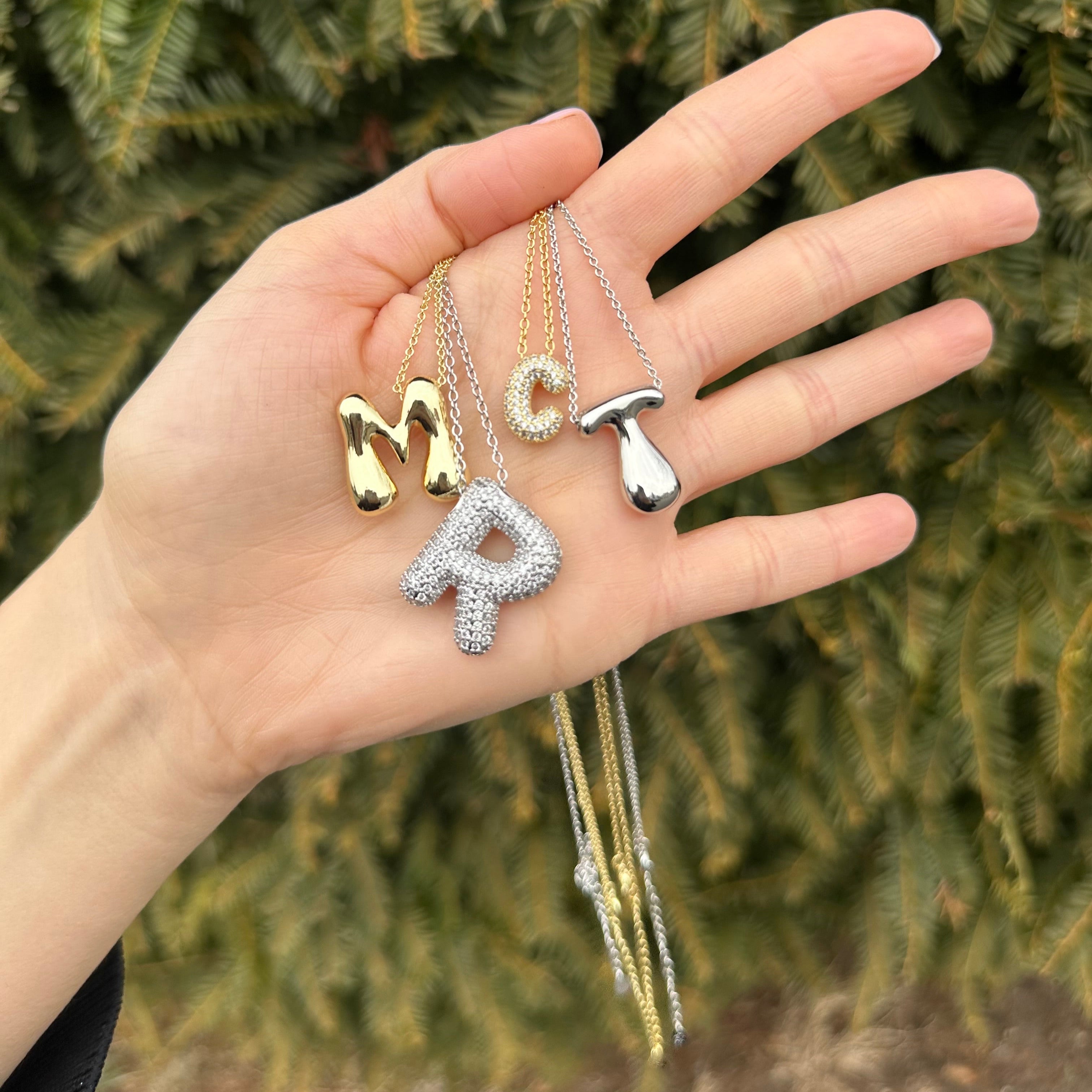 Hailey Bieber-inspired bubble letter initial necklace made from high-quality sterling silver, offering a stylish and durable way to personalize your look with a trendy and chic design. Perfect for layering or solo wear.