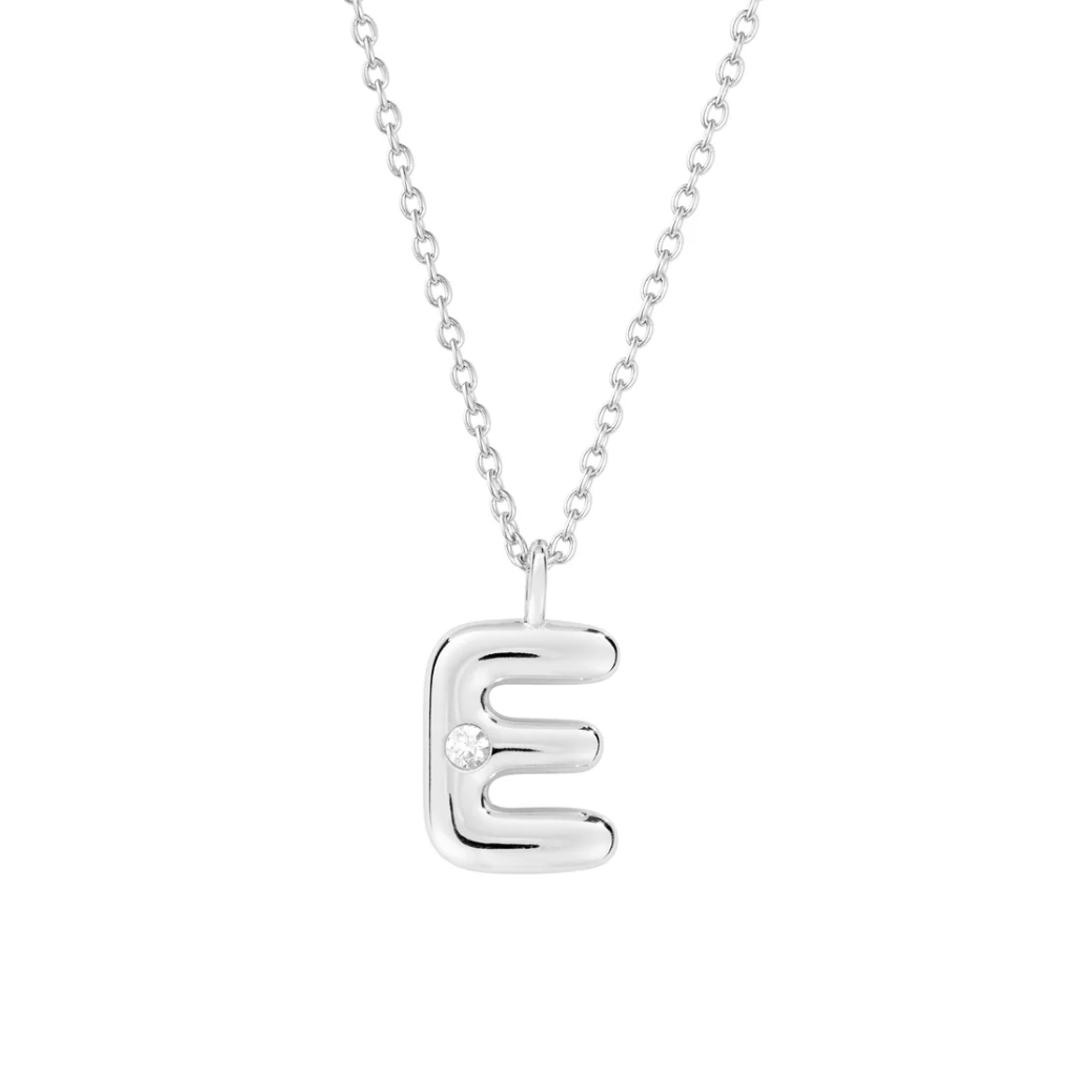 Mini bubble letter initial necklace with bezel, crafted in sterling silver for durability and water-resistance, offering a playful and personalized look for everyday wear.