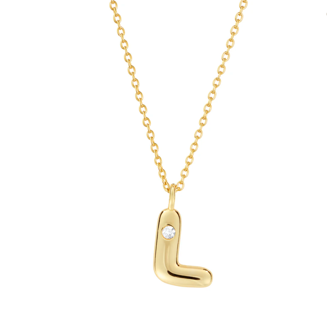 Mini bubble letter initial necklace with bezel, crafted in sterling silver for durability and water-resistance, offering a playful and personalized look for everyday wear.